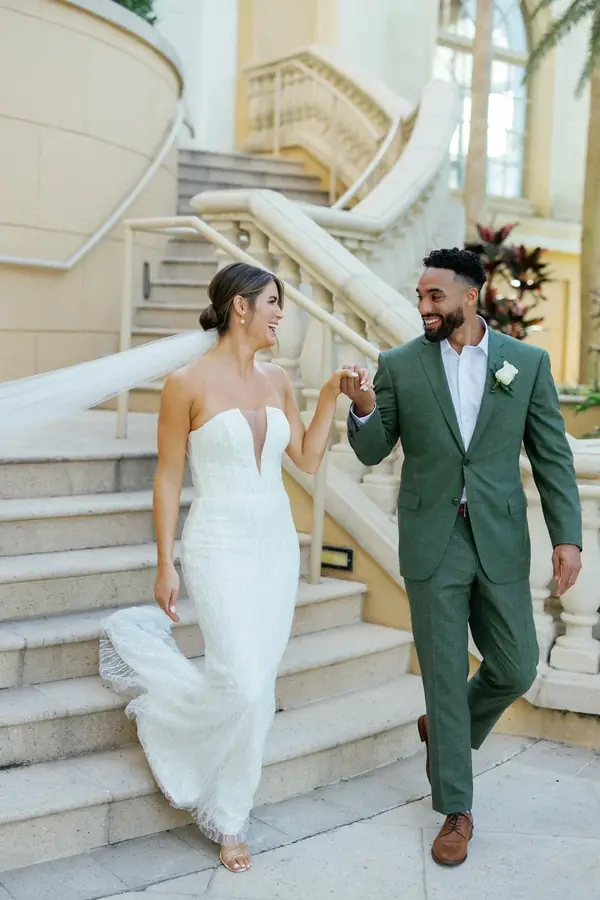 Bride and groom descending a grand staircase
